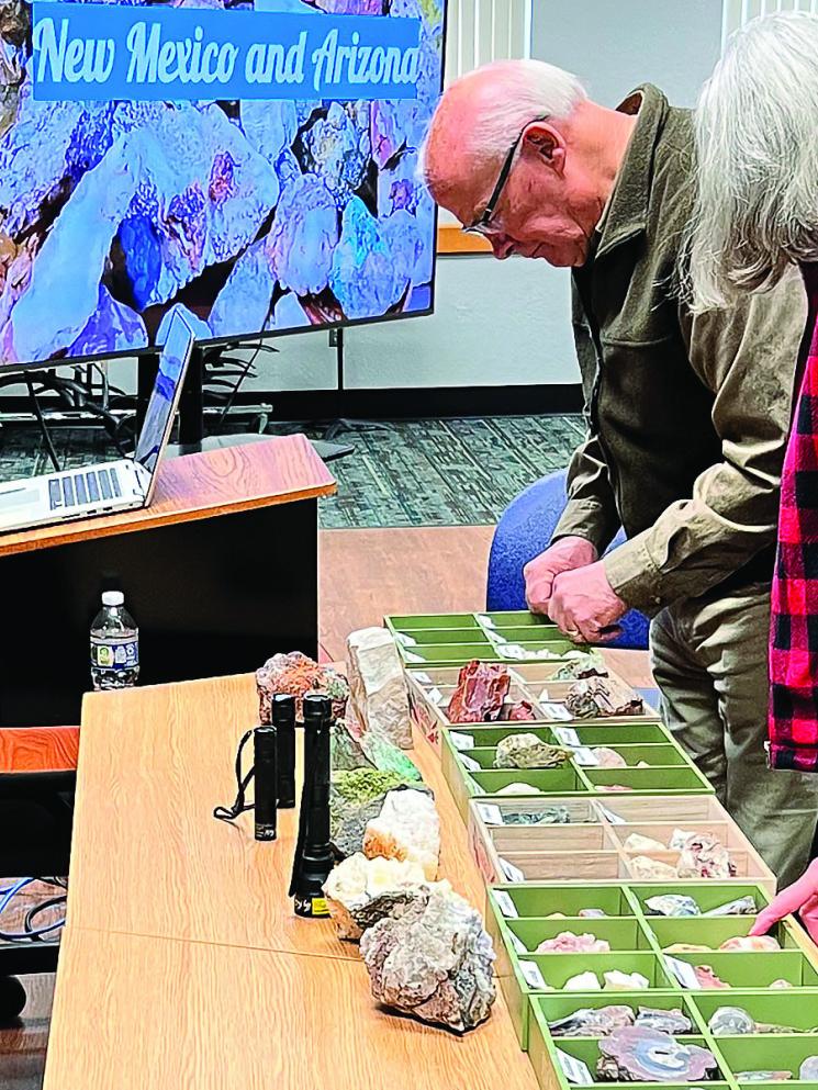 Members looking at display of rocks